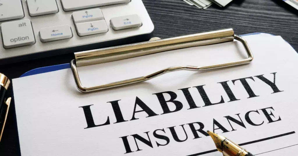 A liability insurance clipboard with a pen and a calculator 