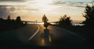 Riding at sunset backed by motorcycle insurance