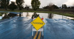 Road sign warning about flooding for flood insurance