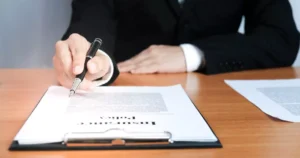 Business professional reviewing a workers compensation insurance policy on a clipboard