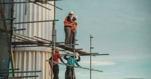 Construction workers wearing safety gear highlighting the importance of workers compensation insurance on job sites