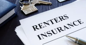 Renters insurance policy document with house key on table
