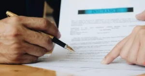 Hands reviewing and signing a cyber liability insurance policy document