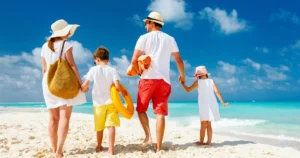 Family walking along a beach vacation destination emphasizing coverage with vacation liability insurance